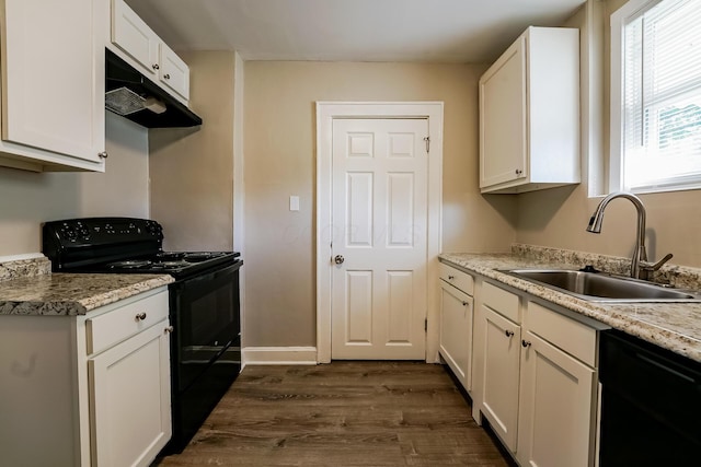 kitchen with light stone counters, sink, black appliances, and white cabinets