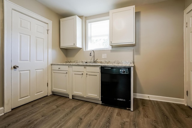 kitchen with dark wood-type flooring, sink, white cabinetry, black dishwasher, and light stone countertops