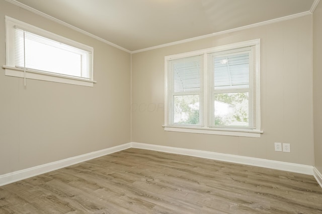 unfurnished room featuring crown molding and light hardwood / wood-style flooring