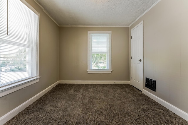 carpeted spare room featuring ornamental molding and a textured ceiling