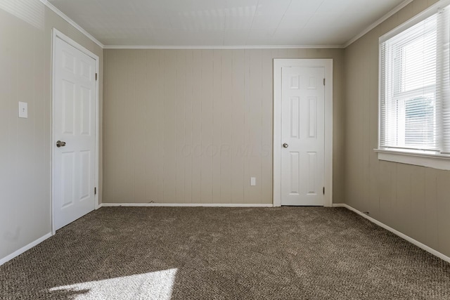 carpeted empty room featuring ornamental molding