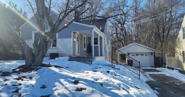 view of front of property with a garage and an outbuilding