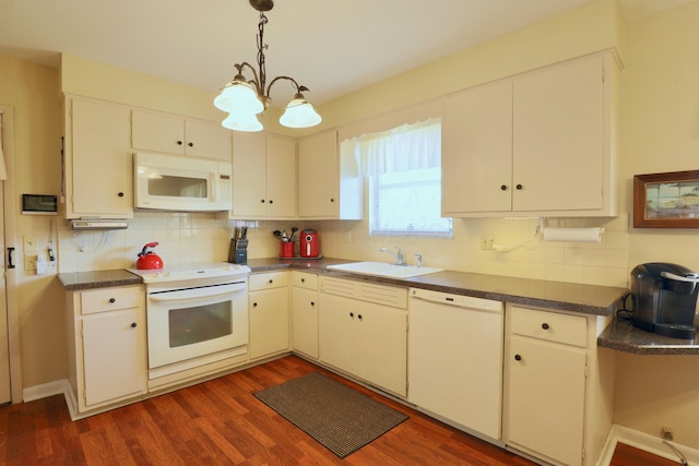 kitchen featuring sink, white appliances, dark wood-type flooring, white cabinets, and decorative light fixtures