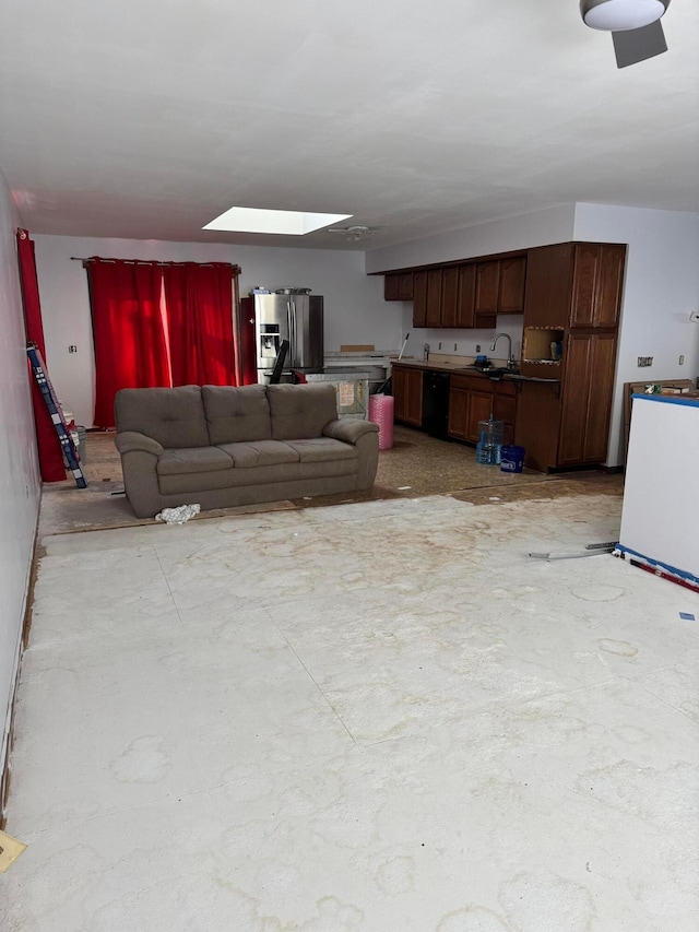 living room featuring sink and a skylight