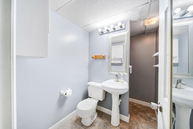 bathroom featuring sink, a paneled ceiling, and toilet