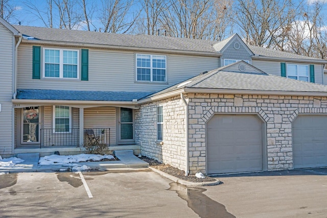 view of front of house featuring a garage and a porch