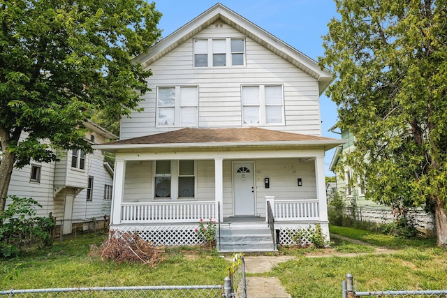 view of front facade with covered porch and a front lawn