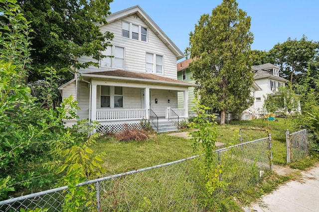 view of front of property with a front yard and covered porch