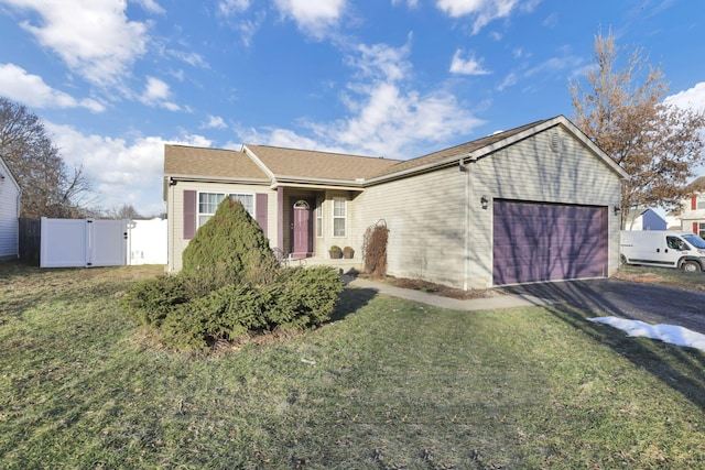 ranch-style house with a garage and a front lawn