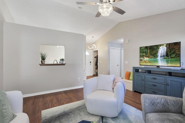 living room featuring ceiling fan, dark hardwood / wood-style flooring, and vaulted ceiling