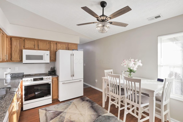 kitchen with ceiling fan, white appliances, lofted ceiling, and dark hardwood / wood-style floors