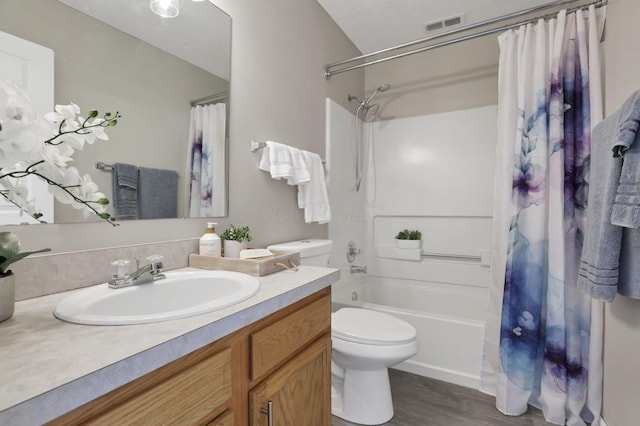 full bathroom featuring vanity, hardwood / wood-style flooring, toilet, and shower / bath combo with shower curtain