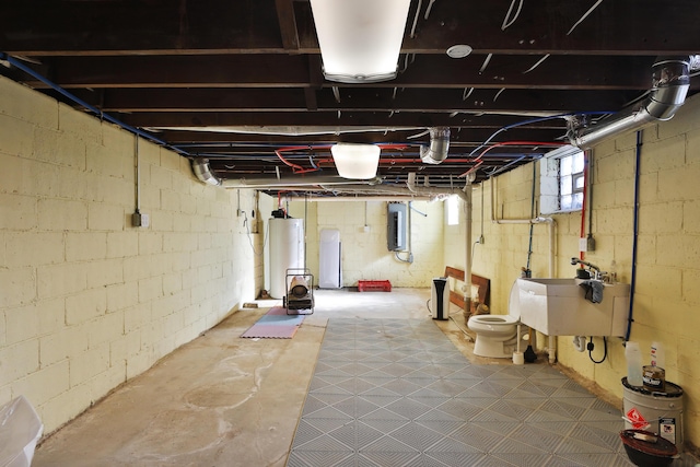 basement featuring sink, gas water heater, and electric panel