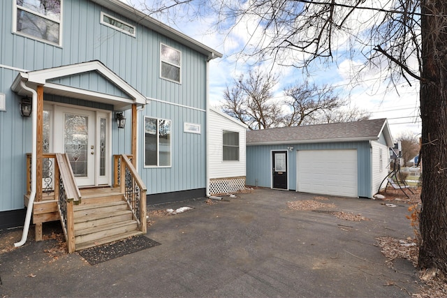 view of front facade with an outbuilding and a garage