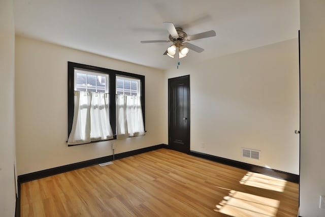 empty room featuring ceiling fan and light wood-type flooring