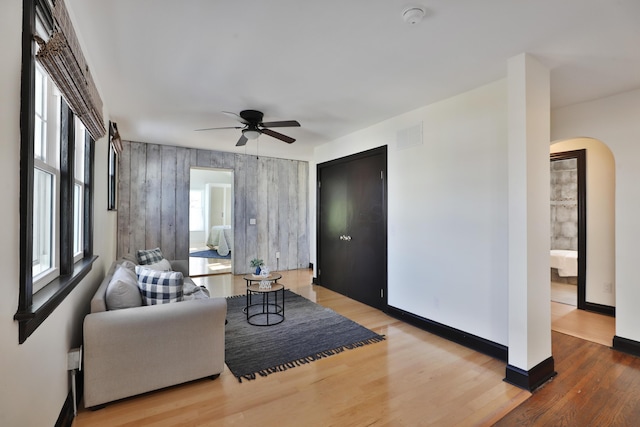 living room featuring wood-type flooring and ceiling fan