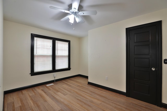 empty room featuring ceiling fan and light wood-type flooring