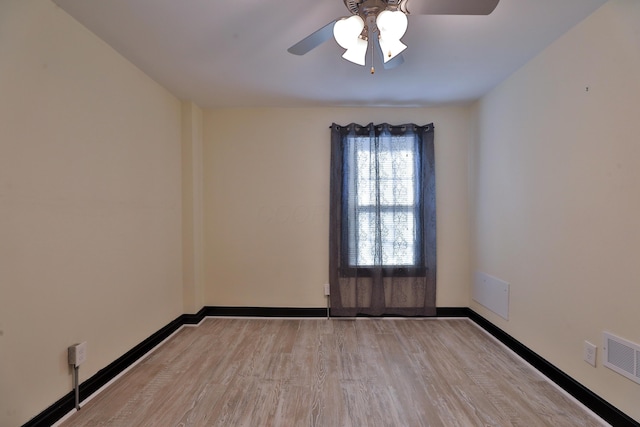 spare room featuring ceiling fan and light hardwood / wood-style flooring