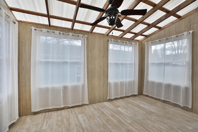 unfurnished sunroom with lofted ceiling and ceiling fan