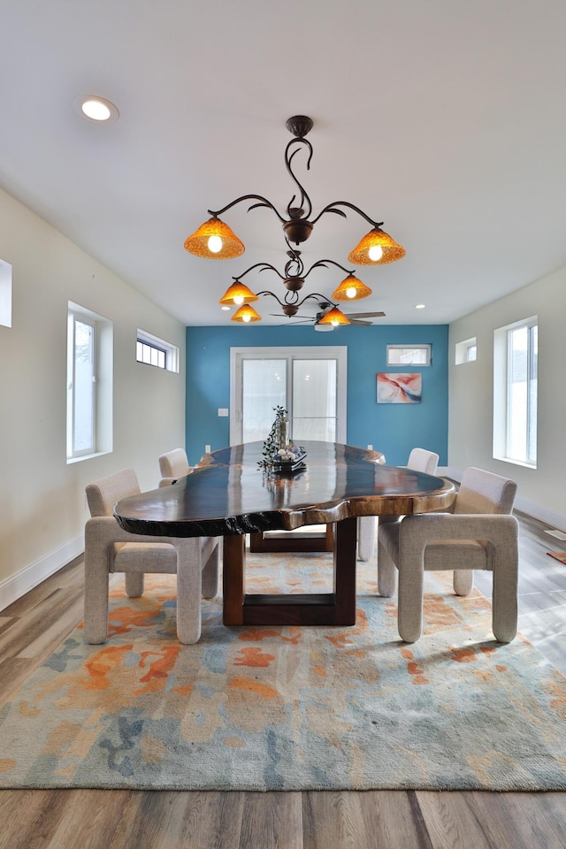 dining area featuring hardwood / wood-style flooring and a chandelier