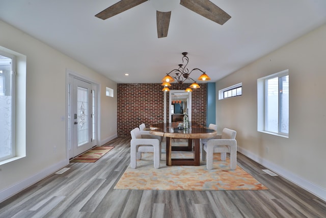 dining room with hardwood / wood-style floors and a notable chandelier