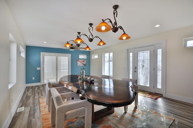 dining space with an inviting chandelier and hardwood / wood-style flooring