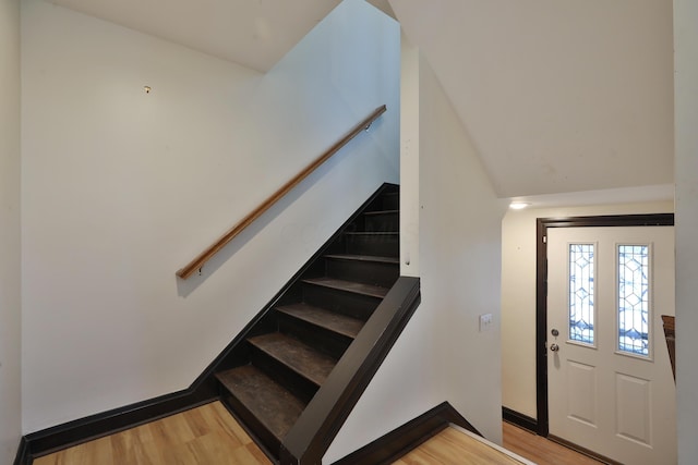 stairs featuring wood-type flooring