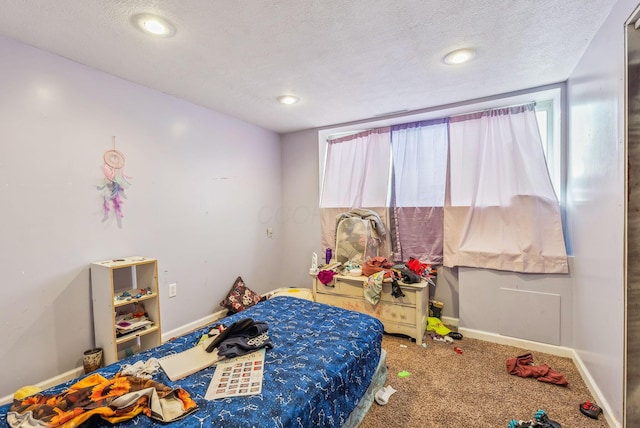 carpeted bedroom featuring a textured ceiling