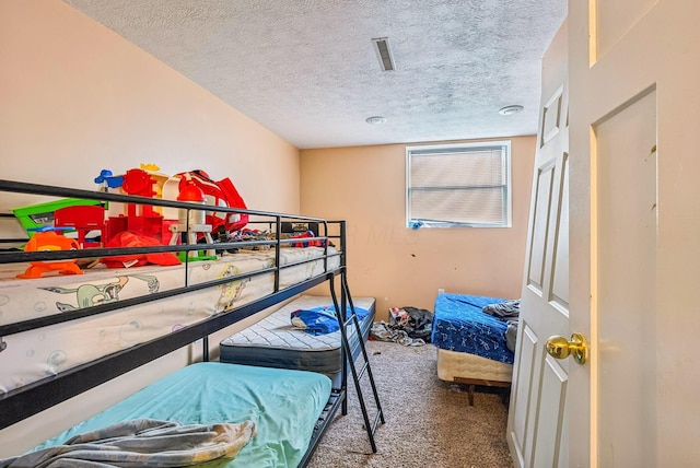 carpeted bedroom with a textured ceiling