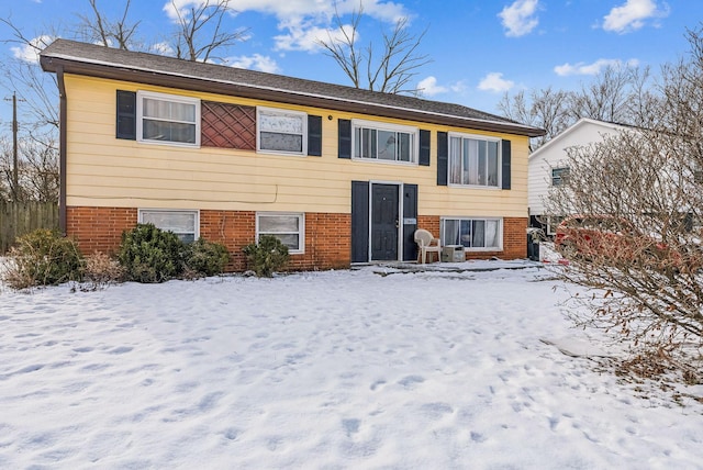 view of snow covered rear of property