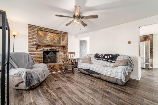 living room featuring a fireplace, dark hardwood / wood-style floors, and ceiling fan