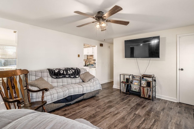 living room with ceiling fan and dark hardwood / wood-style floors