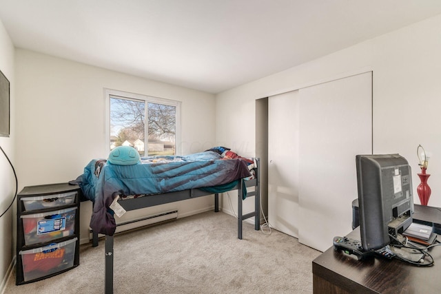 bedroom featuring light colored carpet and a closet