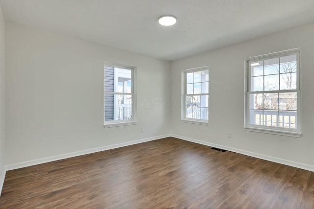 unfurnished room with dark hardwood / wood-style floors