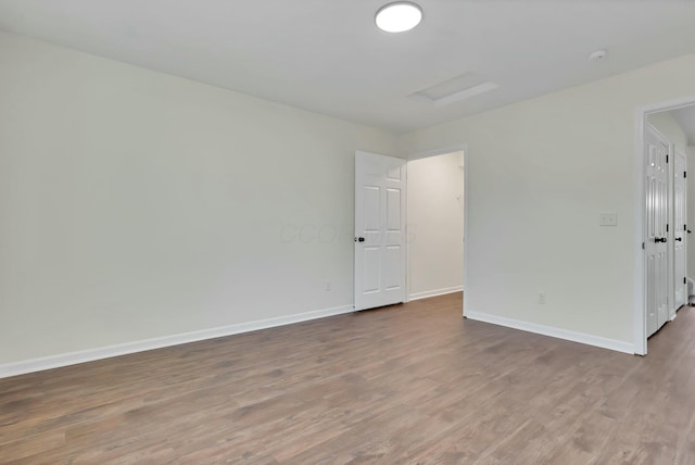 spare room featuring wood-type flooring