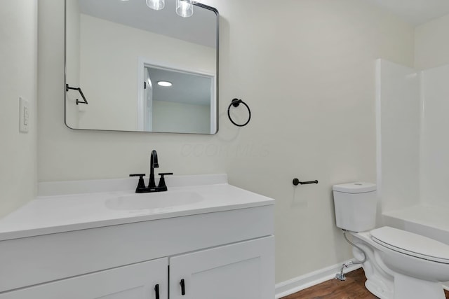 full bathroom featuring hardwood / wood-style flooring, shower / tub combination, vanity, and toilet