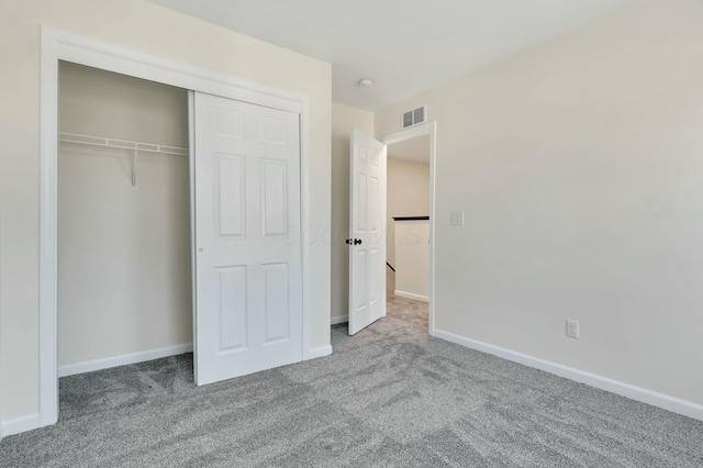 unfurnished bedroom featuring a closet and carpet