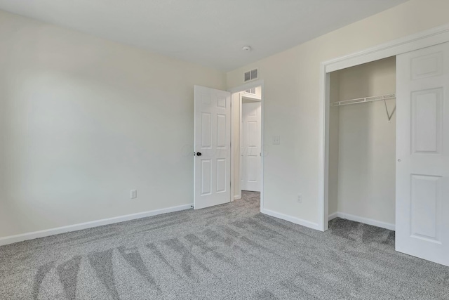 unfurnished bedroom with a closet and carpet