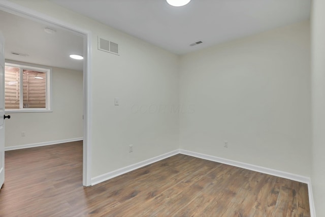 empty room featuring dark wood-type flooring