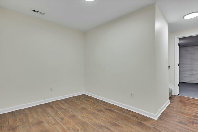 unfurnished room with hardwood / wood-style flooring