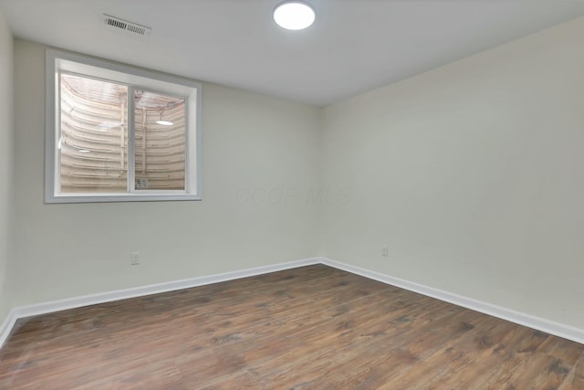 unfurnished room with dark hardwood / wood-style floors