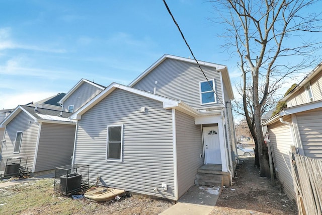 rear view of house featuring central AC