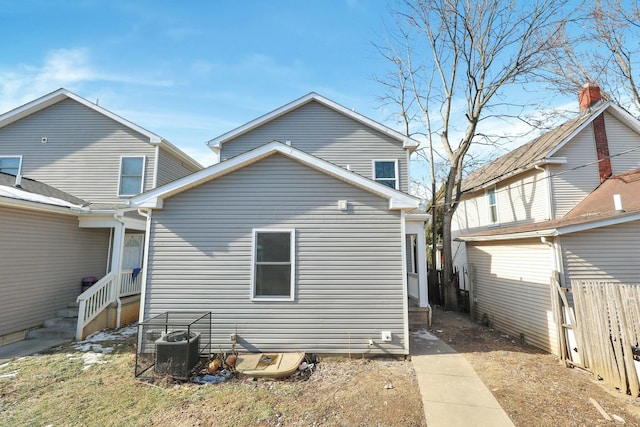 rear view of property featuring central AC unit