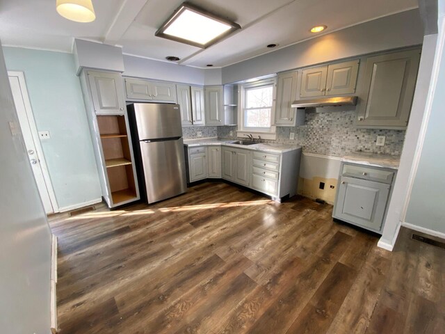 kitchen featuring gray cabinets, tasteful backsplash, stainless steel fridge, and dark hardwood / wood-style flooring