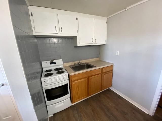 kitchen featuring white range with electric stovetop, tasteful backsplash, white cabinetry, sink, and dark wood-type flooring