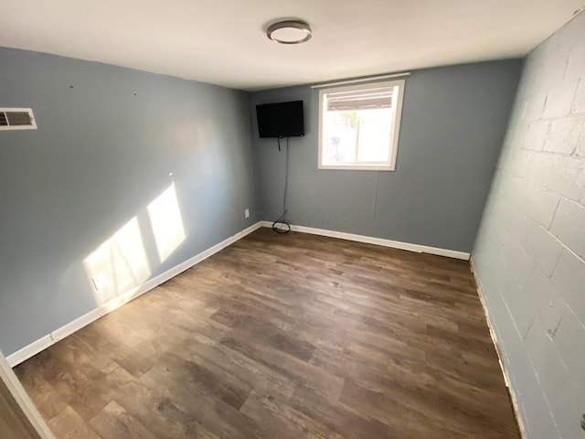 unfurnished room featuring dark wood-type flooring