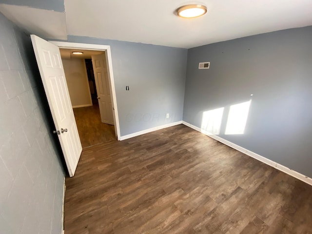 spare room featuring dark hardwood / wood-style flooring