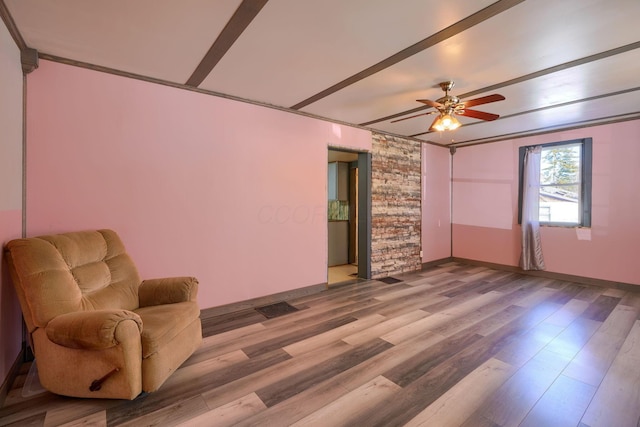 living area featuring hardwood / wood-style floors and ceiling fan