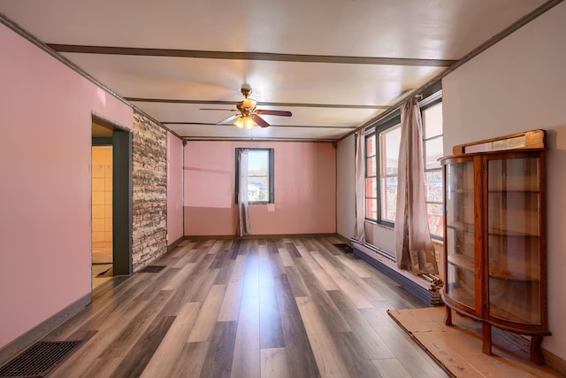 spare room with hardwood / wood-style flooring and ceiling fan