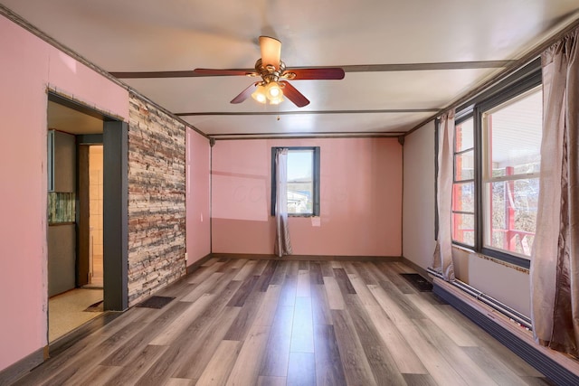 spare room featuring hardwood / wood-style floors and ceiling fan